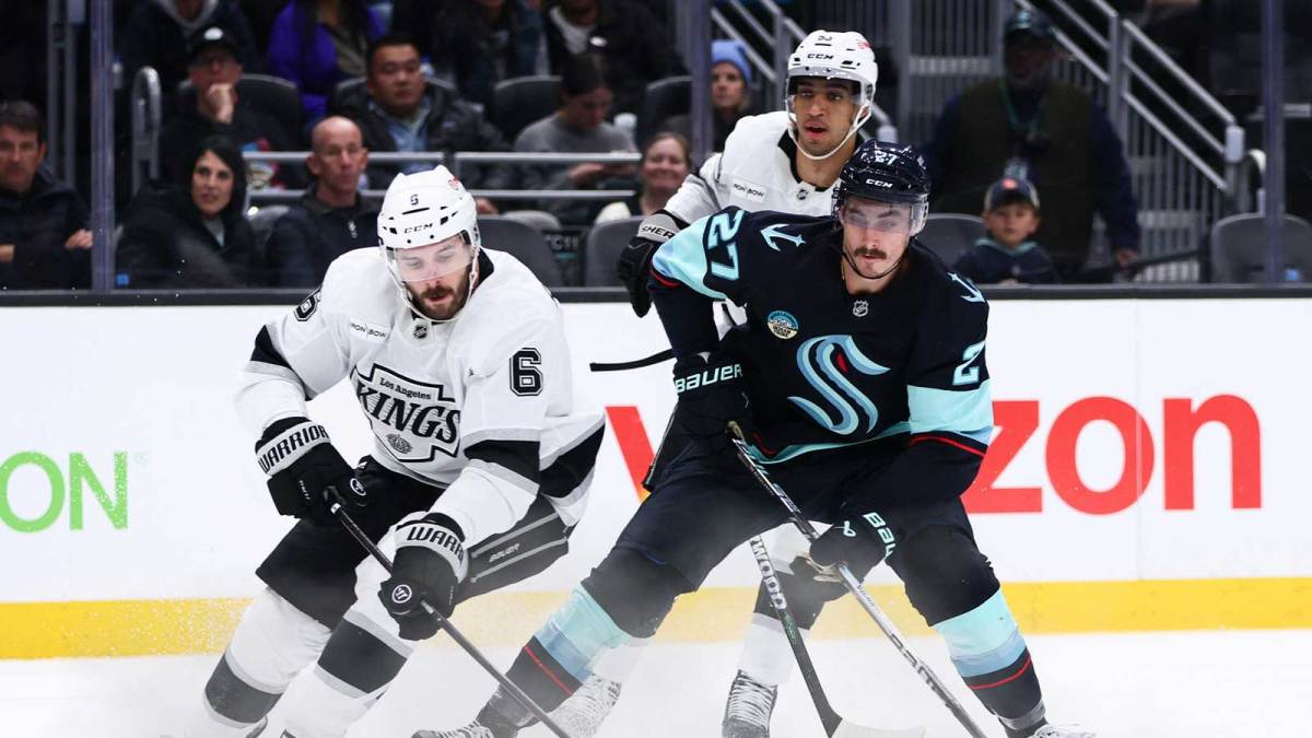 Los Angeles Kings defenseman Joel Edmundson (6) and Seattle Kraken left wing Mason Marchment (27) battle for the puck in the third period at Climate Pledge Arena.