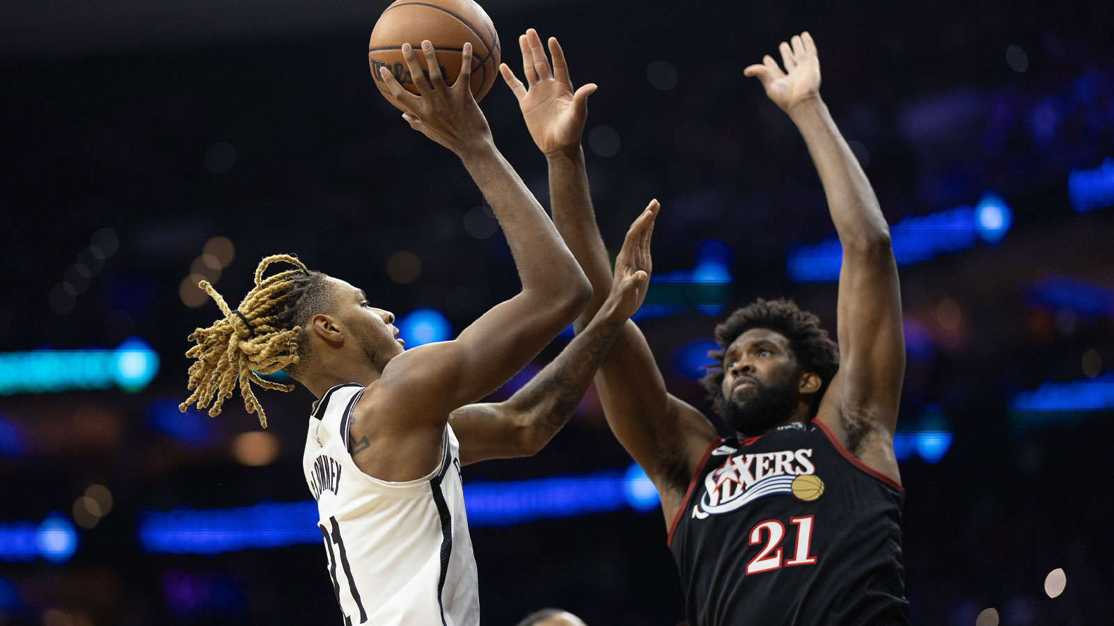 Brooklyn Nets forward Noah Clowney (21) drives for a shot against Philadelphia 76ers center Joel Embiid (21) during the second quarter at Xfinity Mobile Arena.