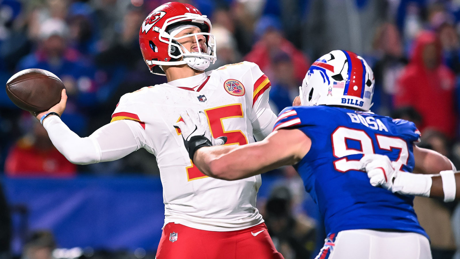 Kansas City Chiefs quarterback Patrick Mahomes (15) throws a pass under pressure from Buffalo Bills defensive end Joey Bosa (97) in the fourth quarter at Highmark Stadium.