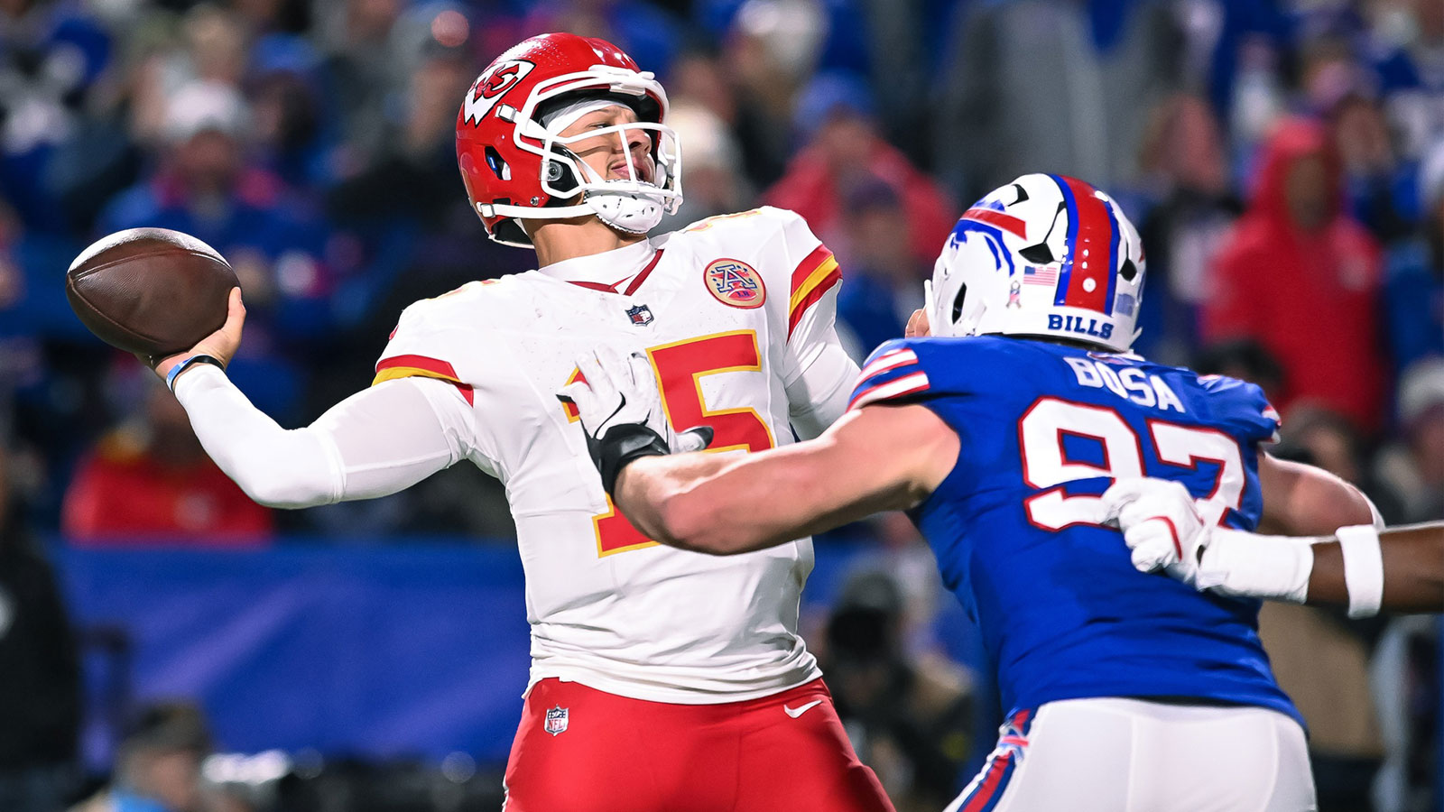 Kansas City Chiefs quarterback Patrick Mahomes (15) throws a pass under pressure from Buffalo Bills defensive end Joey Bosa (97) in the fourth quarter at Highmark Stadium. 