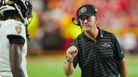 Baltimore Ravens head coach John Harbaugh talks with quarterback Lamar Jackson (8) during the second half against the Kansas City Chiefs at GEHA Field at Arrowhead Stadium.