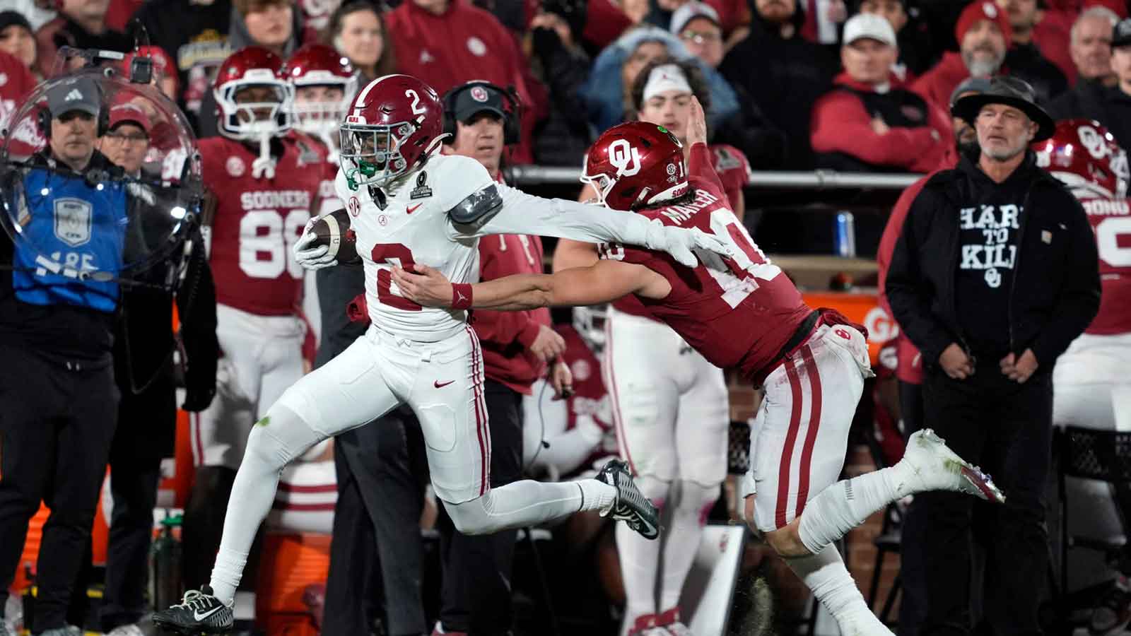 Alabama Crimson Tide defensive back Zabien Brown (2) runs past Oklahoma Sooners quarterback John Mateer (10) as he returns an interception for a touchdown during a first-round College Football Playoff game between the University of Oklahoma Sooners (OU) and the Alabama Crimson Tide at Gaylord Family Ð Oklahoma Memorial Stadium in Norman, Okla., Friday, Dec. 19, 2025.