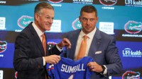UF Athletic Director Scott Stricklin and new UF head football coach Jon Sumrall pose with a jersey at a press conference James W. “Bill” Heavener Football Training Center in Gainesville, FL on Monday, December 1, 2025.