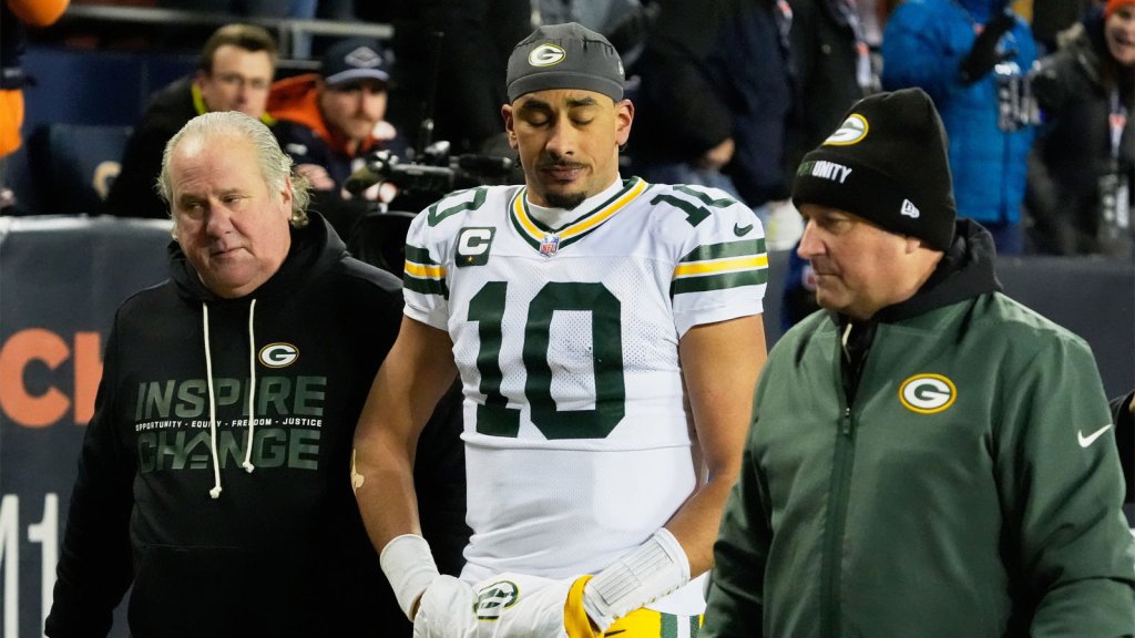 Green Bay Packers quarterback Jordan Love (10) walks off the field with an apparent injury against the Chicago Bears during the second quarter at Soldier Field.