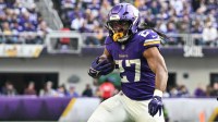 Minnesota Vikings running back Jordan Mason (27) rushes the ball against the Washington Commanders during the second half at U.S. Bank Stadium.