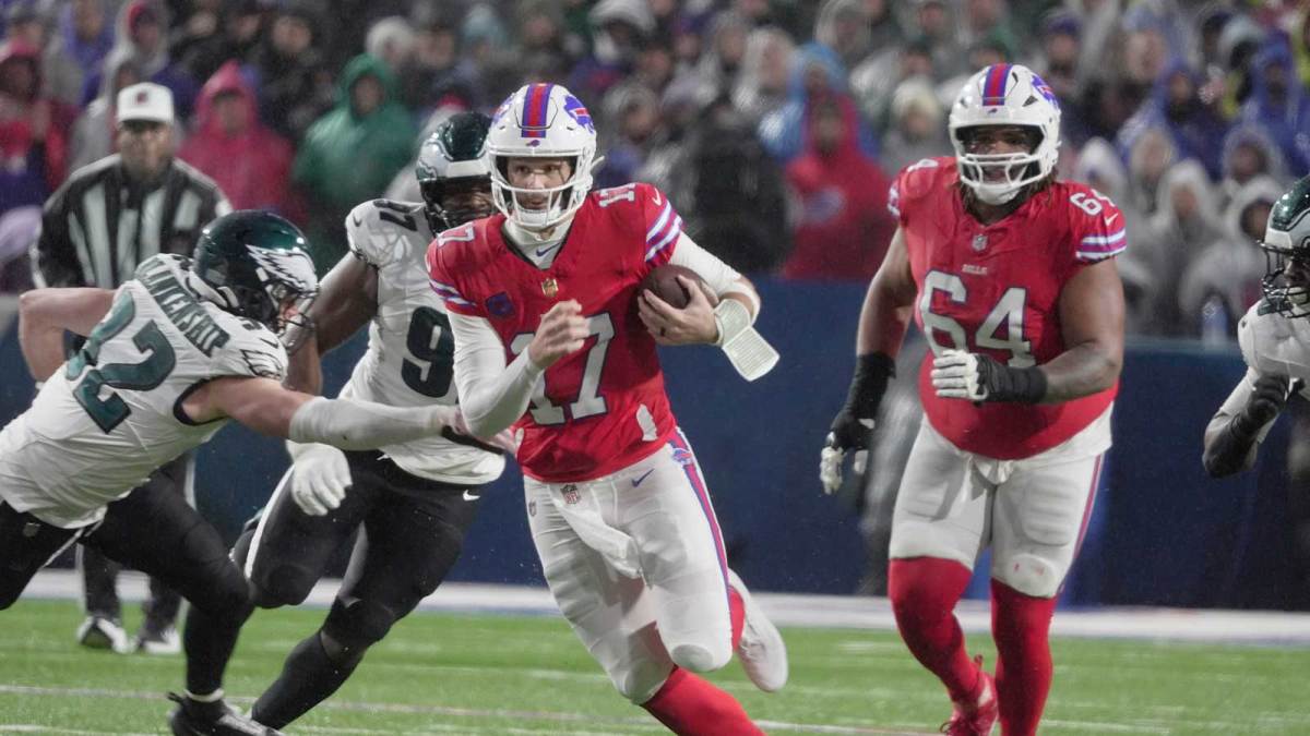 Buffalo Bills quarterback Josh Allen runs with the ball for several yards before being tripped up by Philadelphia Eagles linebacker Jalyx Hunt during first half action against the Philadelphia Eagles at Highmark Stadium in Orchard Park on Dec. 28, 2025.