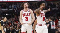 Chicago Bulls guard Josh Giddey (3) and guard Coby White (0) celebrate a defensive stop against the Washington Wizards during the second half at United Center.