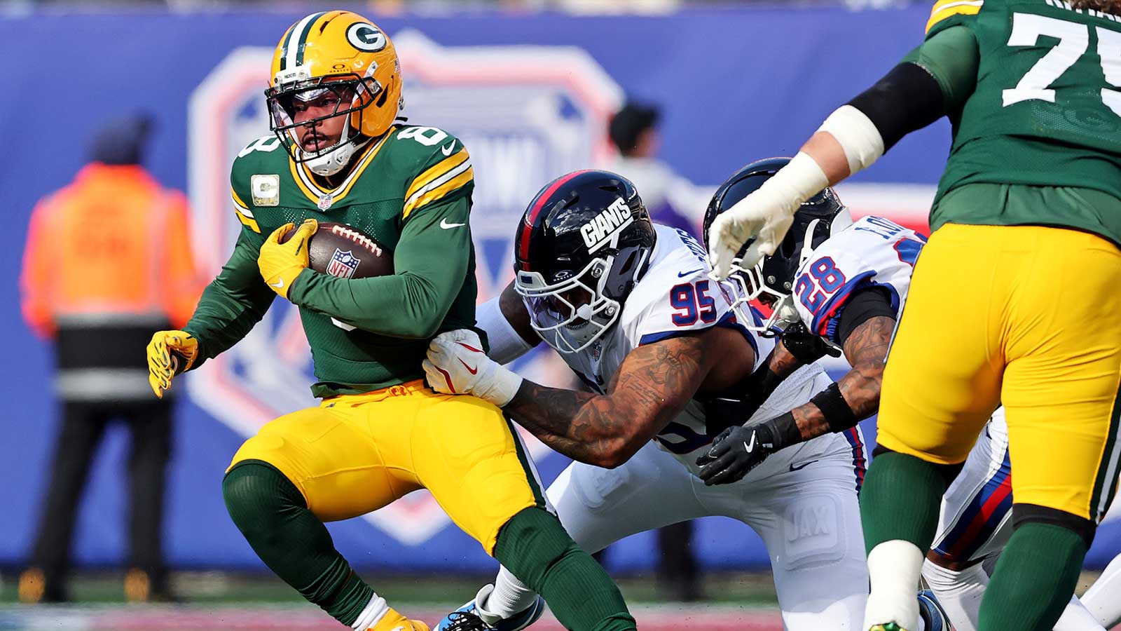 Green Bay Packers running back Josh Jacobs (8) runs the ball against New York Giants defensive tackle Roy Robertson-Harris (95) during the first quarter at MetLife Stadium. 