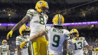 Green Bay Packers running back Josh Jacobs (8) and Green Bay Packers wide receiver Christian Watson (9) celebrate after a touchdown against the Detroit Lions during the third quarter at Ford Field.