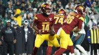 Washington Commanders quarterback Josh Johnson (14) prepares to throw the ball against the Philadelphia Eagles during the second half at Northwest Stadium.