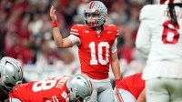 Ohio State Buckeyes quarterback Julian Sayin (10) motions during the Big Ten Conference championship game against the Indiana Hoosiers at Lucas Oil Stadium in Indianapolis on Dec. 6, 2025. Ohio State lost 13-10.