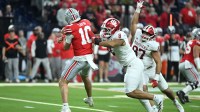 Indiana Hoosiers defensive lineman Stephen Daley (8) tackles Ohio State Buckeyes quarterback Julian Sayin (10) in the first quarter during the 2025 Big Ten championship game at Lucas Oil Stadium.
