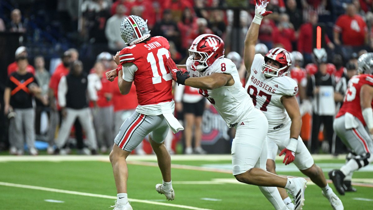 Indiana Hoosiers defensive lineman Stephen Daley (8) tackles Ohio State Buckeyes quarterback Julian Sayin (10) in the first quarter during the 2025 Big Ten championship game at Lucas Oil Stadium.