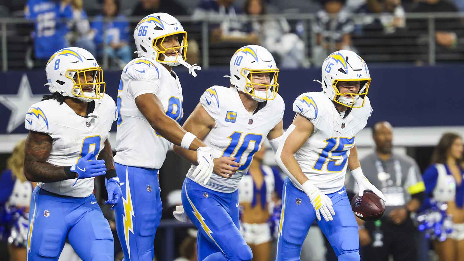 Los Angeles Chargers wide receiver Ladd McConkey (15) returns to the bench with running back Omarion Hampton (8), tight end Will Dissly (89) and quarterback Justin Herbert (10) after catching a touchdown pass from Herbert against the Dallas Cowboys during the second quarter at AT&T Stadium.