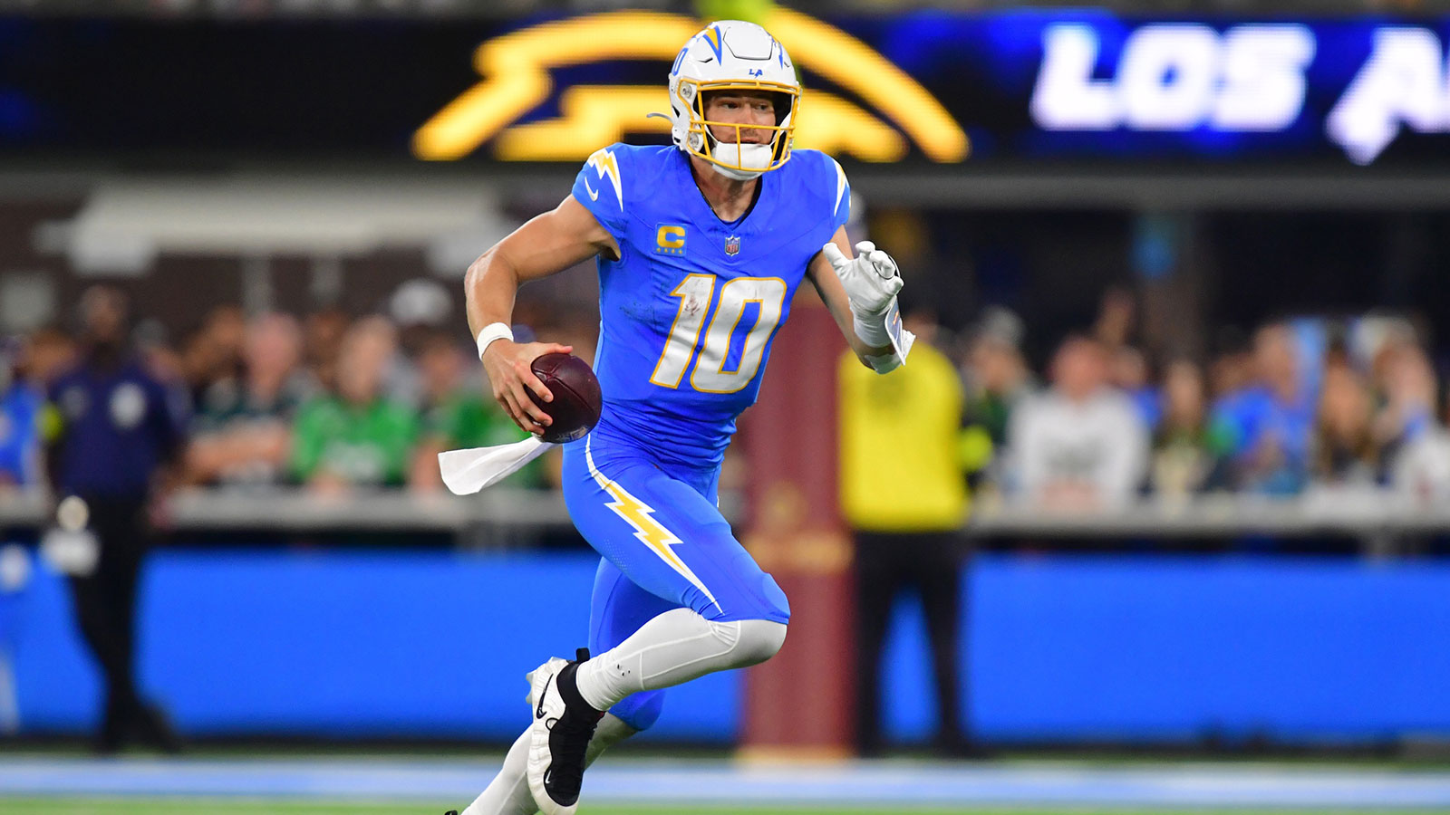 Los Angeles Chargers quarterback Justin Herbert (10) runs against the Philadelphia Eagles in the second half at SoFi Stadium.