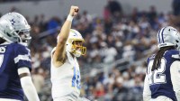Los Angeles Chargers quarterback Justin Herbert (10) celebrates a touchdown by running back Omarion Hampton (not pictured) against the Dallas Cowboys during the fourth quarter at AT&T Stadium.