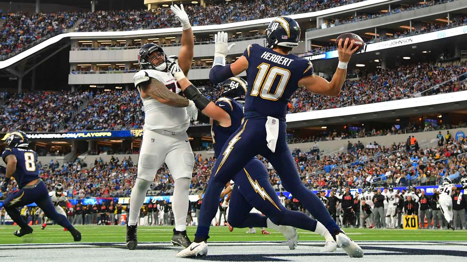 Los Angeles Chargers quarterback Justin Herbert (10) throws from the end zone as Houston Texans defensive tackle Tommy Togiai (72) applies the pressure during the second half at SoFi Stadium. 