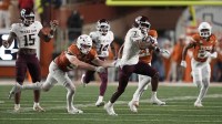 Texas A&M Aggies wide receiver KC Concepcion (7) returns a punt while defended by defensive lineman Ethan Burke (91) during the first half against the Texas Longhorns at Darrell K Royal-Texas Memorial Stadium.