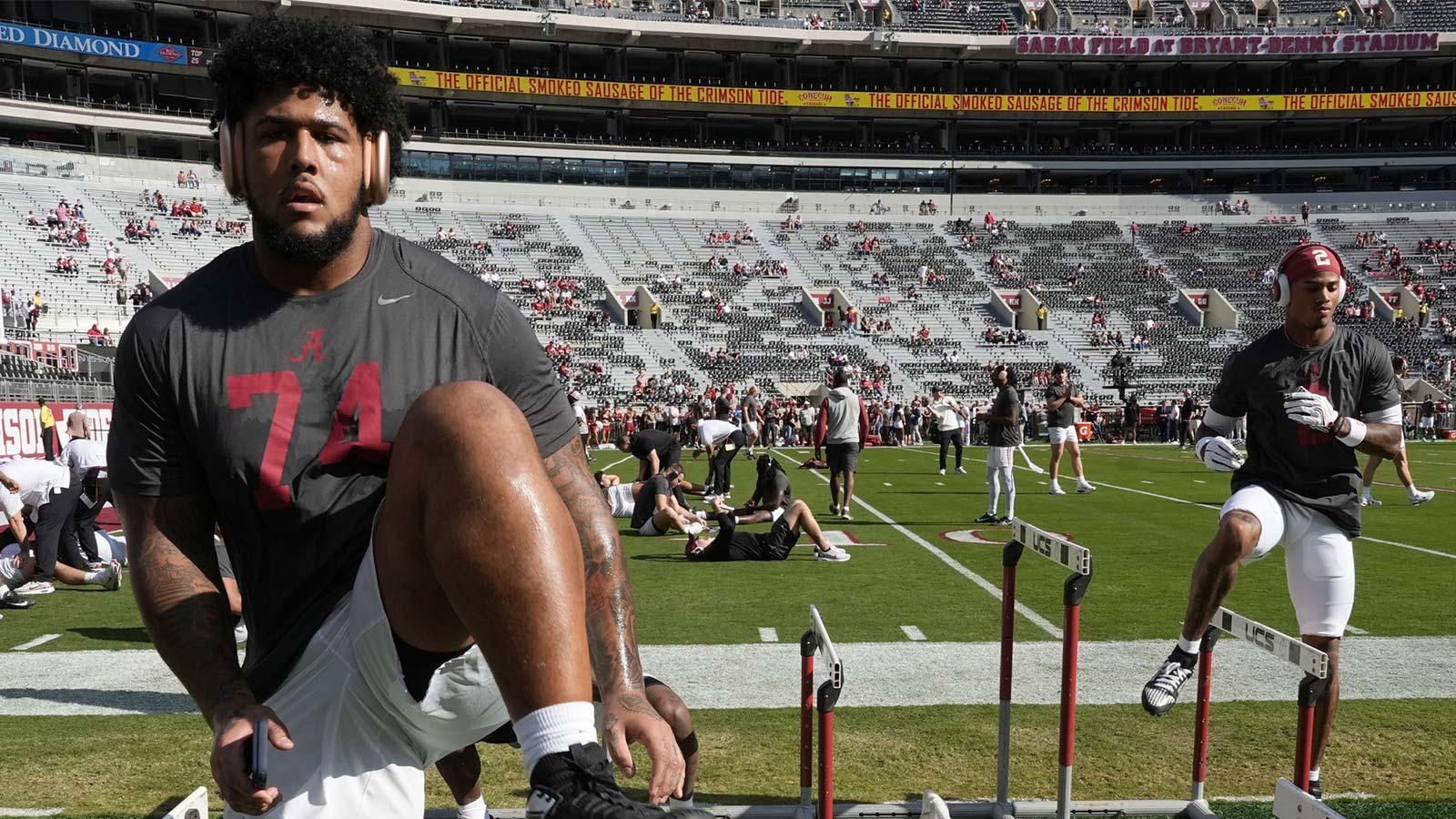 Alabama offensive lineman Kadyn Proctor (74) and Alabama wide receiver Ryan Williams (2) use hurdles to loose up before the game with Oklahoma at Saban Field at Bryant-Denny Stadium at Saban Field at Bryant-Denny Stadium. 