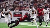 Houston Texans wide receiver Jayden Higgins (81) runs after making a catch as Tampa Bay Buccaneers defensive tackle Calijah Kancey (94) defends at NRG Stadium.