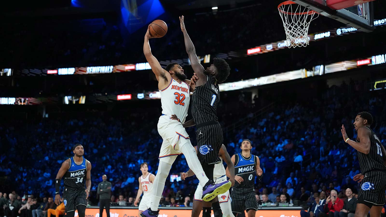 New York Knicks center Karl-Anthony Towns (32) goes to the basket as Orlando Magic forward Jonathan Isaac (1) defends during the second quarter at T-Mobile Arena.