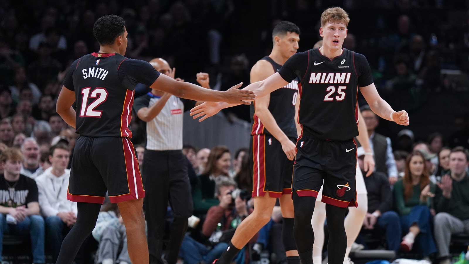 Miami Heat guard Kasparas Jakucionis (25) and guard Dru Smith (12) react after a play against the Boston Celtics in the first quarter at TD Garden.