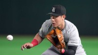Yomiuri Giants first baseman Kazuma Okamoto (25) fields a ground ball against the Los Angeles Dodgers during the fifth inning at Tokyo Dome.