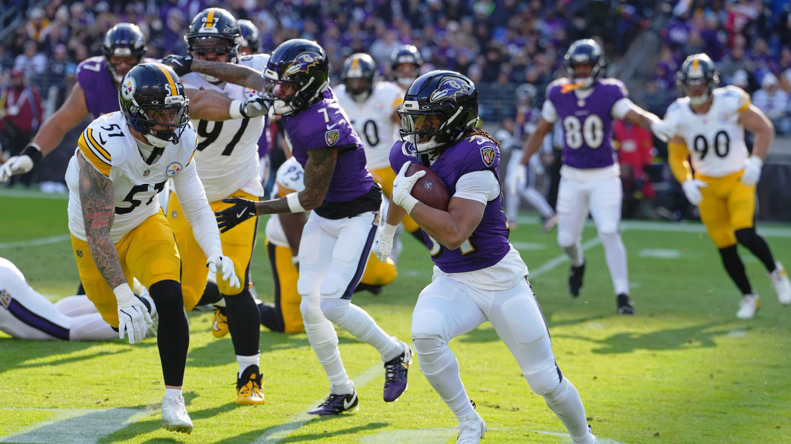 Baltimore Ravens running back Keaton Mitchell (34) runs with the ball against the Pittsburgh Steelers during the first half at M&T Bank Stadium.