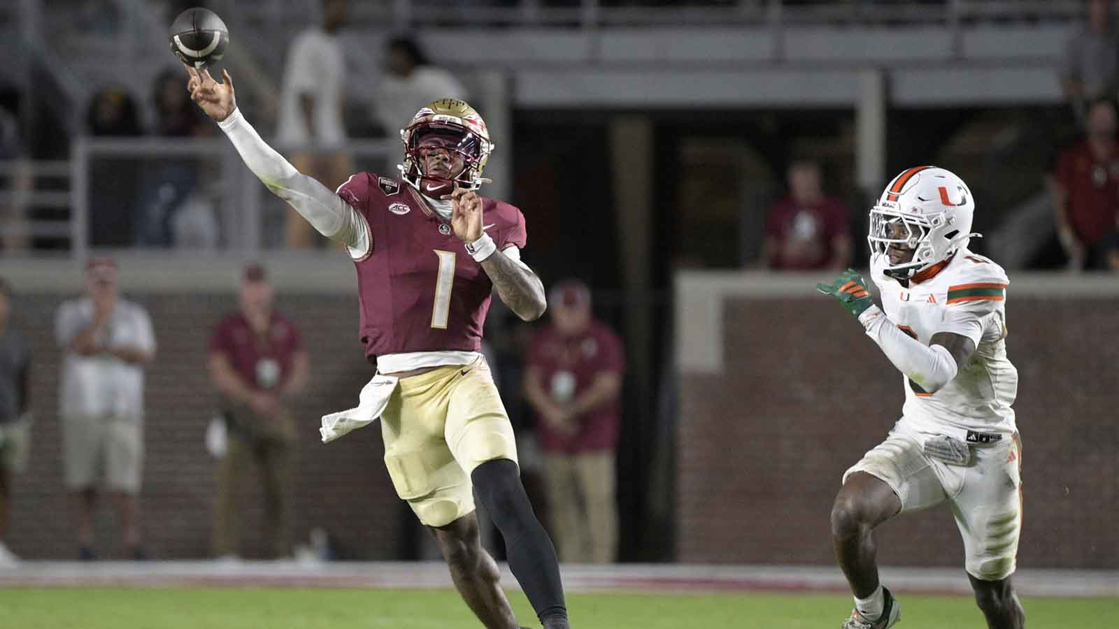 Florida State Seminoles quarterback Tommy Castellanos (1) throws against Miami Hurricanes defensive back Keionte Scott during the second half at Doak S. Campbell Stadium.