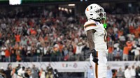Miami Hurricanes defensive back Keionte Scott (0) celebrates a touchdown after an interception against the Ohio State Buckeyes in the second quarter during the 2025 Cotton Bowl and quarterfinal game of the College Football Playoff at AT&T Stadium.