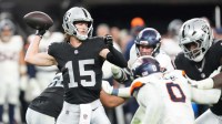 Las Vegas Raiders quarterback Kenny Pickett (15) throws downfield against the Denver Broncos during the second half at Allegiant Stadium.