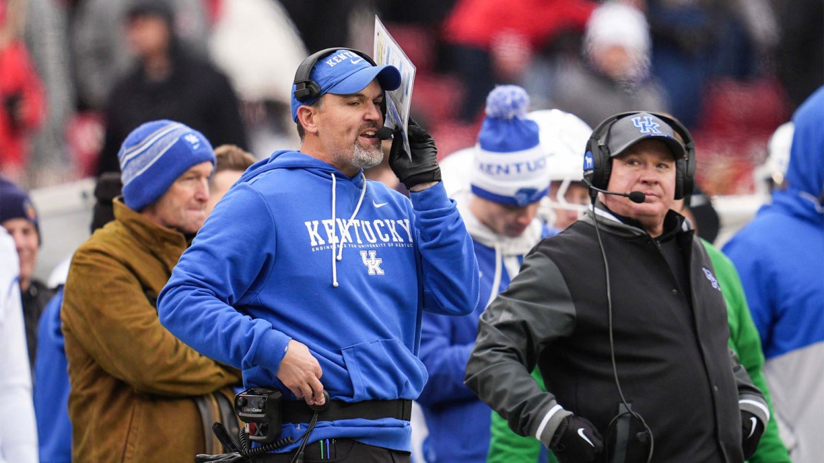 Kentucky defensive coordinator Brad White and head football coach Mark Stoops on the sidelines as UK athletic director Mitch Barnhart stands behind them at left during the loss against UofL Saturday, November 29, 2025 in Louisville, Kentucky at L&N Federal Credit Union Stadium. The Cards shut out the Cats 41-0.