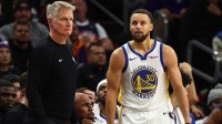 Golden State Warriors guard Stephen Curry (30) reacts alongside head coach Steve Kerr against the Phoenix Suns in the second half at Mortgage Matchup Center.