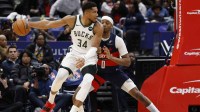 Milwaukee Bucks forward Giannis Antetokounmpo (34) drives to the basket as Washington Wizards guard Bilal Coulibaly (0) defends in the third quarter at Capital One Arena.