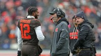 Cleveland Browns quarterback Shedeur Sanders (12) talks with coach Kevin Stefanski during a game against the Tennessee Titans on Dec. 7, 2025, in Cleveland.