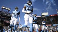 Tennessee Titans safety Kevin Winston Jr. (23) and cornerback Darrell Baker Jr. (39) run onto the field before the game against the Houston Texans.