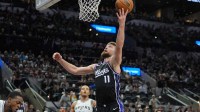 Kings forward Domantas Sabonis (11) shoots in the second half against the San Antonio Spurs at Frost Bank Center with Suns logo in the background