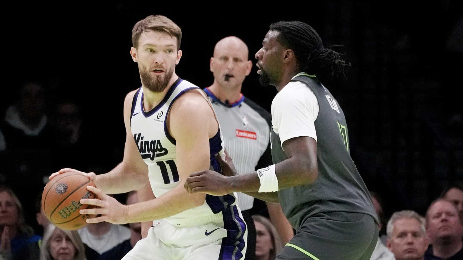 Kings center Domantas Sabonis (11) works around Minnesota Timberwolves center Naz Reid (11) in the second quarter at Target Center