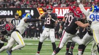 Atlanta Falcons quarterback Kirk Cousins (18) throws a touchdown pass against the Los Angeles Rams during the first quarter at Mercedes-Benz Stadium.
