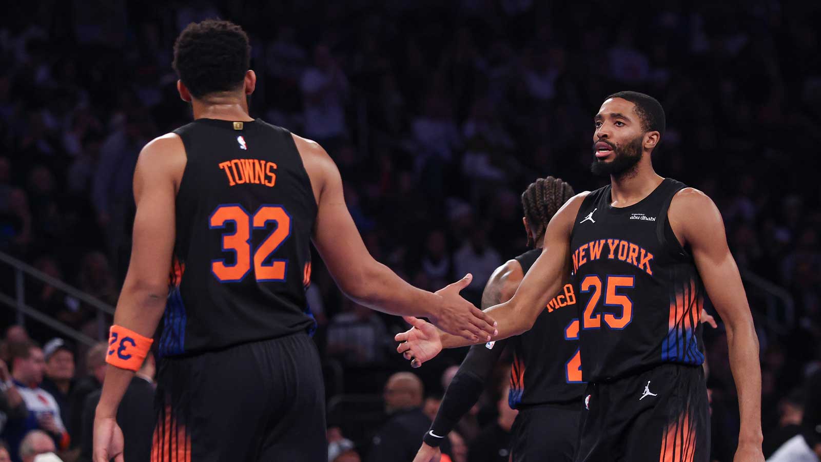 New York Knicks guard Mikal Bridges (25) slaps hands with center Karl-Anthony Towns (32) during the first half against the Milwaukee Bucks at Madison Square Garden.