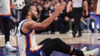 Knicks guard Jalen Brunson (11) reacts after getting called for a foul in the third quarter against the Miami Heat at Madison Square Garden with a young Knicks fan in the background