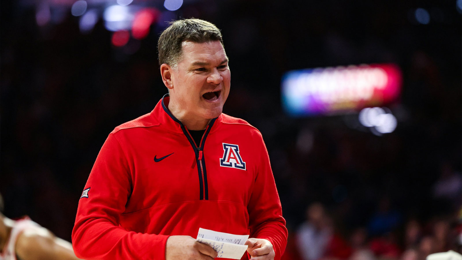 Arizona Wildcats head coach Tommy Lloyd yells out towards his bench during the first half of the game against the Auburn Tigers at McKale Memorial Center.