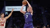 Charlotte Hornets guard Kon Knueppel (7) shoots a three-pointer against Chicago Bulls forward Matas Buzelis (14) during the second quarter at Spectrum Center.