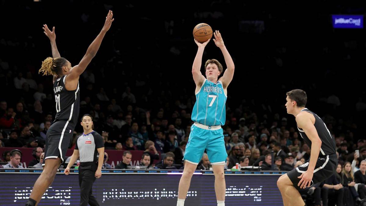 Charlotte Hornets guard Kon Knueppel (7) shoots a three point shot against Brooklyn Nets forward Noah Clowney (21) and guard Egor Demin (8) during the second quarter at Barclays Center.