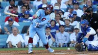 Philadelphia Phillies left fielder Kyle Schwarber (12) strikes out in front of Los Angeles Dodgers catcher Will Smith (16) in the sixth inning during game four of the NLDS round for the 2025 MLB playoffs at Dodger Stadium.