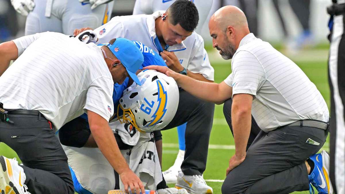 Dr. Frank Petrigliano, team Orthopaedic surgeon, right, and staff check on Los Angeles Chargers offensive tackle Trey Pipkins (79) after an injury in the first half against the Denver Broncos at SoFi Stadium. Mandatory Credit: Jayne Kamin-Oncea-Imagn Images