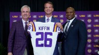 LSU president Wade Rousse, left, LSU new head coach Lane Kiffin and LSU athletic director Verge Ausberry stand together at South Stadium Club at Tiger Stadium.