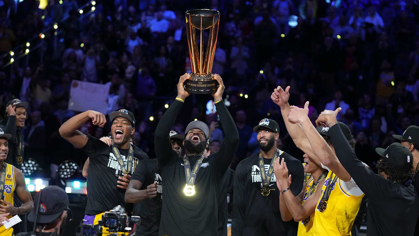 Los Angeles Lakers forward LeBron James (23) celebrates with teammates and the NBA Cup after defeating the Indiana Pacers in the in season tournament championship final at T-Mobile Arena.