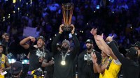 Los Angeles Lakers forward LeBron James (23) celebrates with teammates and the NBA Cup after defeating the Indiana Pacers in the in season tournament championship final at T-Mobile Arena.