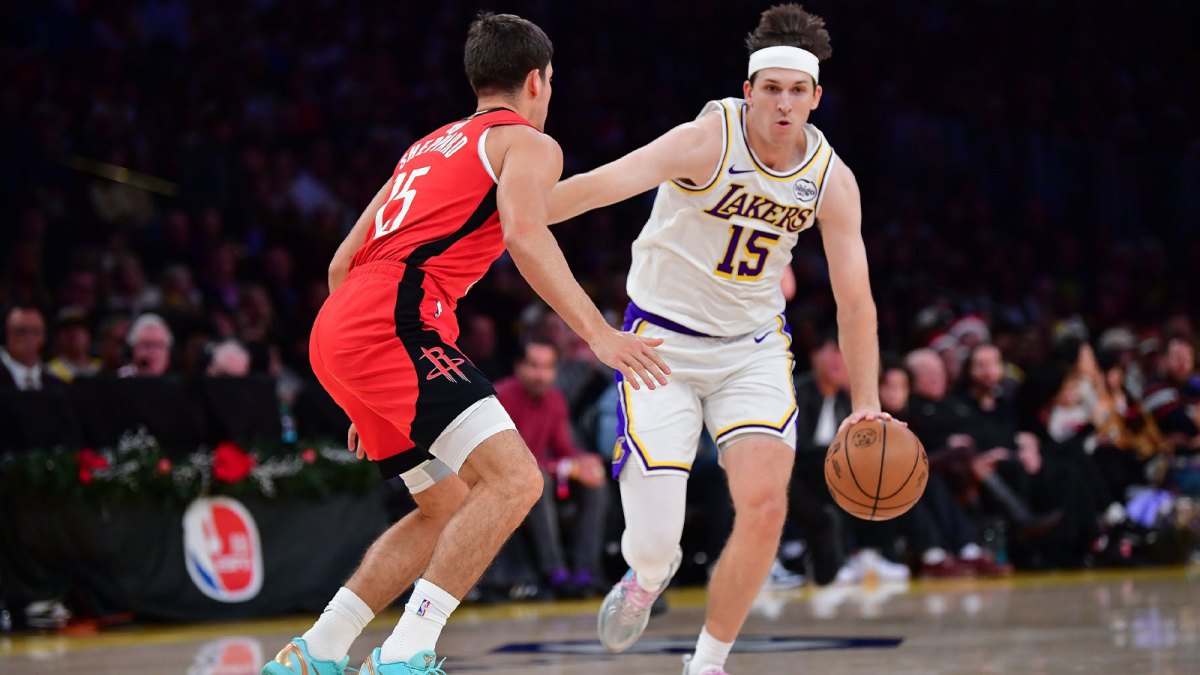 Los Angeles Lakers guard Austin Reaves (15) moves the ball against Houston Rockets guard Reed Sheppard (15) during the first half at Crypto.com Arena. Mandatory Credit: Gary A. Vasquez-Imagn Images